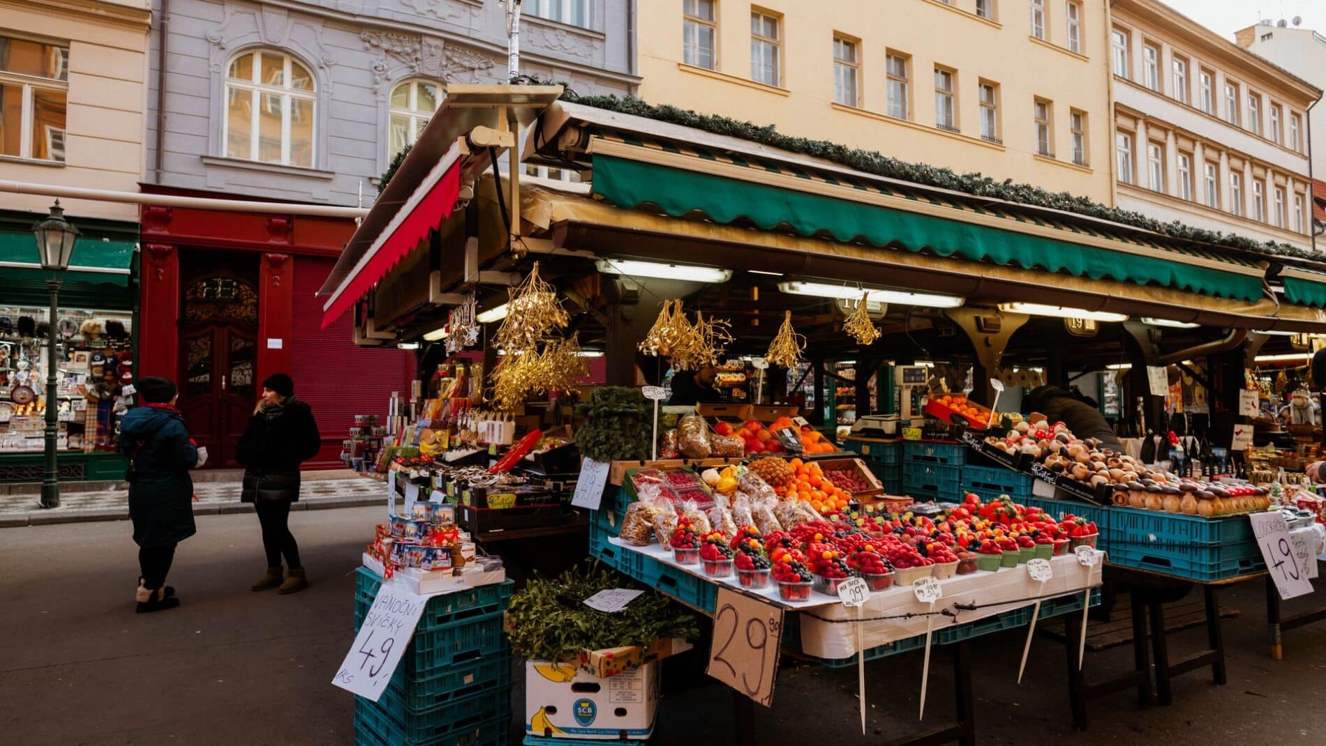 Explore a lively outdoor market stall with assorted fruits and vegetables, perfect for a local shopping experience.