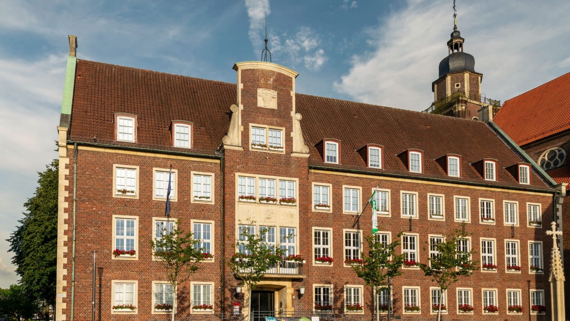 A historic town hall building with classic architecture basking in the vibrant sunlight outdoors.