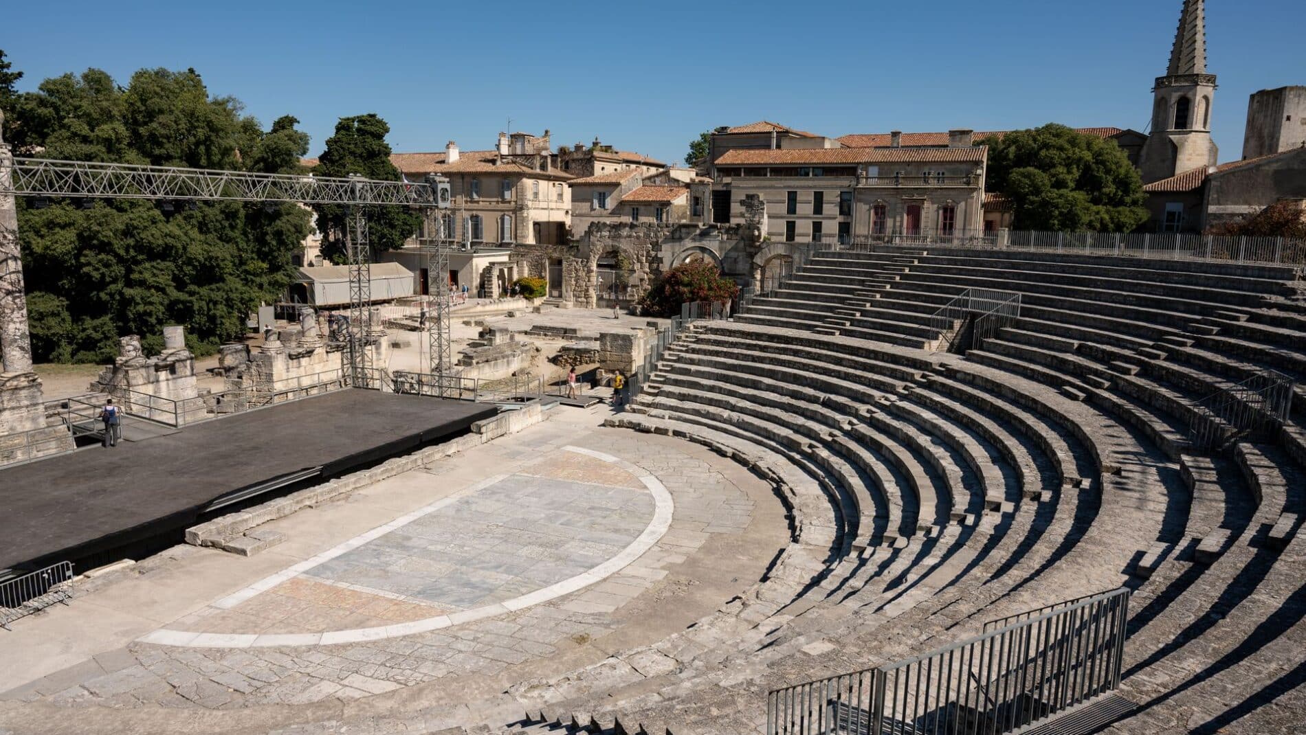 Discover the historic Roman amphitheater in Arles, capturing timeless architecture under clear skies.