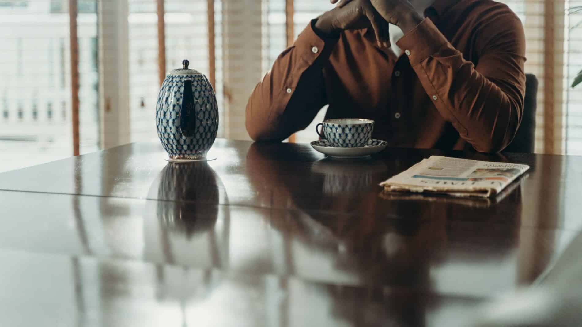 A person enjoying a hot beverage in a serene indoor setting, perfect for relaxation.